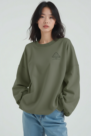 Person wearing a green bell curve sweatshirt with a small logo on a white background