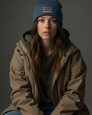 Woman wearing a brown jacket and kindacool blue born in the late 1900s beanie
